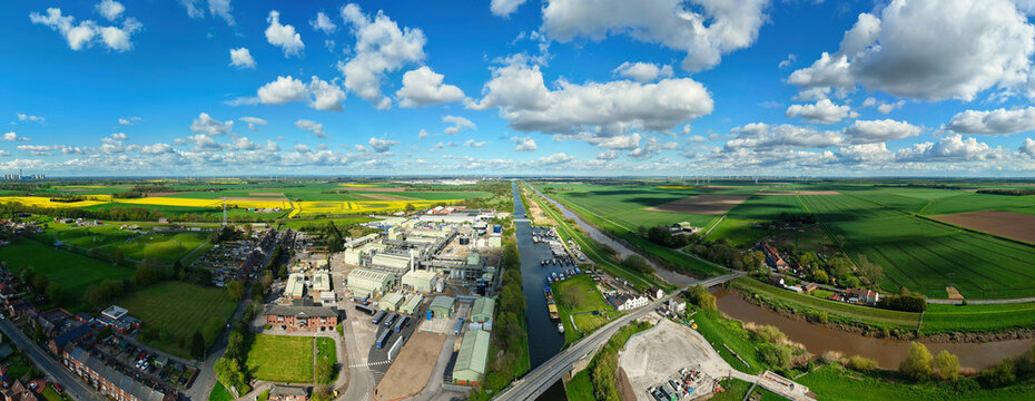 Aerial view of the Croda Chemical Plant and Marina alongside a canal, surrounded by green and yellow agricultural fields under a blue sky in Rawcliffe Bridge, England, United Kingdom.