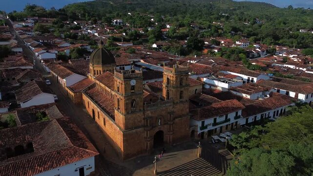 Aerial drone fly-through between the stone towers of the Immaculate Conception Cathedral in Barichara, Colombia.