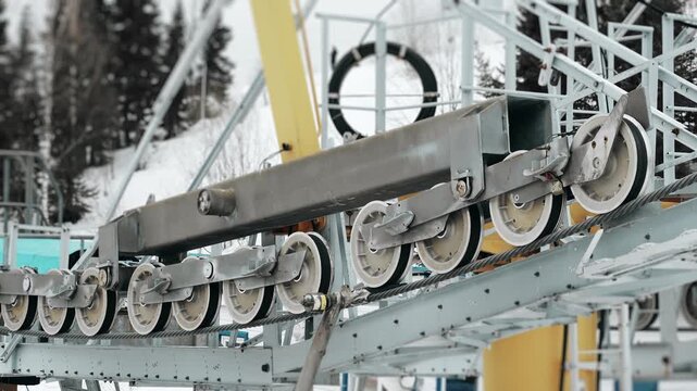 Close up of ski lift cable mechanism and rollers, mountain transport engineering system, winter resort infrastructure and technical equipment detail.