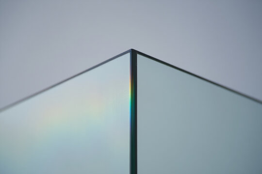 Close up of thick glass corner showing rainbow refraction light effect