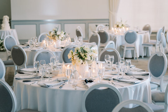 Refined event hall prepared for guests. Sophisticated celebration venue arranged with elegance and care