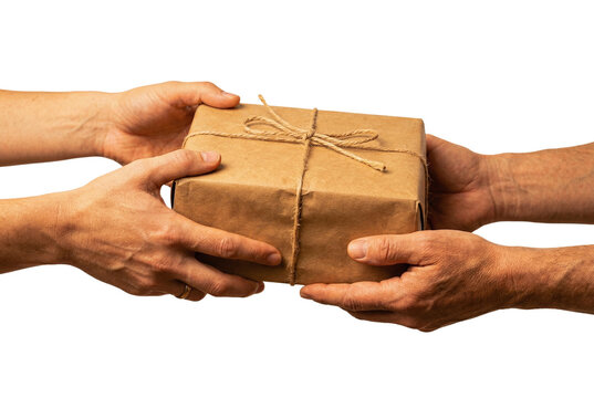 Hands passing brown paper package tied with string