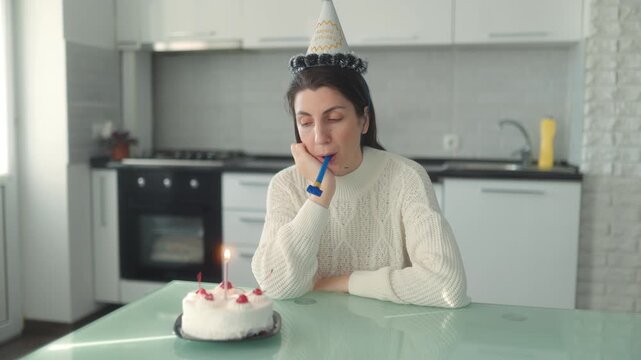 Medium Shot One Bored Woman Blowing Horn Near Lit Birthday Cake