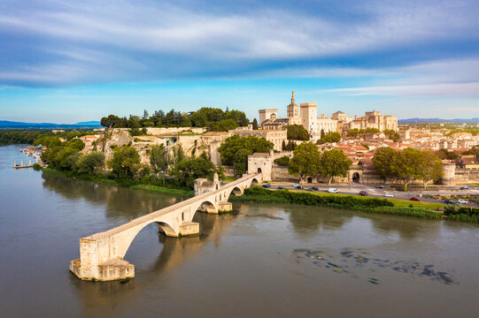 Beautiful view of Avignon with famous bridge Saint-Benezet, medieval architecture along the Rhone River in Avignon, France. The Pont Saint Benezet and the Papal palace in Avignon, South France.