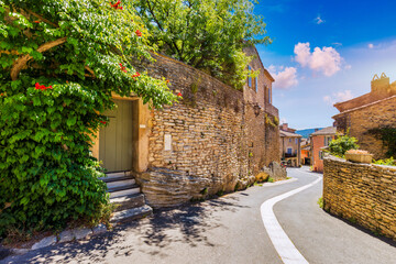 Fototapeta premium View of Goult, a small typical town in Provence, France. Discover the stunning hilltop village of Goult in Provence on a sunny day. Ancient hilltop village of Goult, Provence, France.