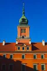 Obraz premium Royal Castle in Warsaw Architecture: Historic Red Brick Facade and Turquoise Turret Tower, Polish National Heritage and Landmark in Castle Square, European Travel and Culture Concept