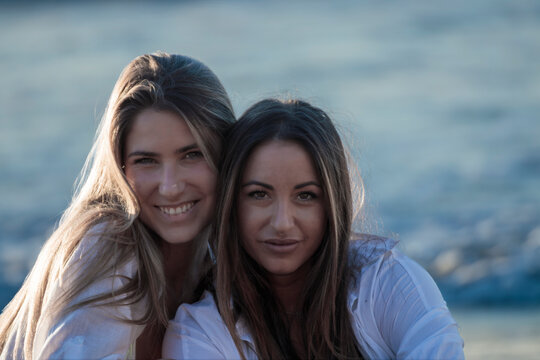 Two women smiling close-up representing friendship and bonding
