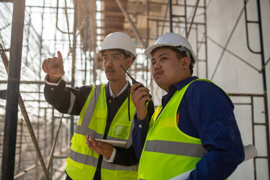 Construction safety briefing job site professional interaction urban environment close-up view team collaboration