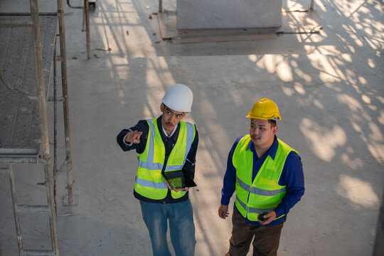 Construction project management meeting industrial site professional interaction indoor eye-level teamwork concept