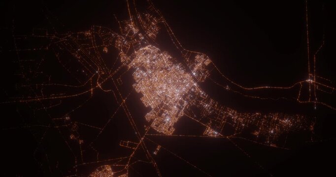 Basra (Iraq) aerial view at night. View on modern city from space. Camera is zooming in, rotating counterclockwise