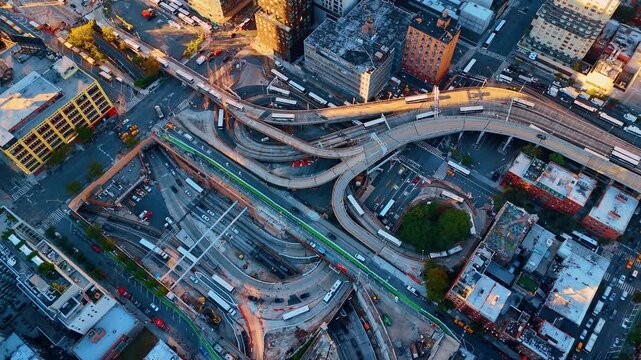 Top down aerial view of highway interchange and ramps. Complex urban transport infrastructure with bus terminal ramps and city streets seen from directly above.