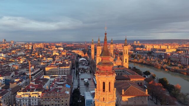 Aerial View Capturing Sunset Glow Illuminating Cathedral Domes And Tranquil River Reflections. Zaragoza. Spain 