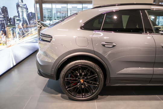 electric Porsche Macan displayed in showroom, eco-friendly dynamic styling and high-performance characteristics, Frankfurt - January 25, 2025
