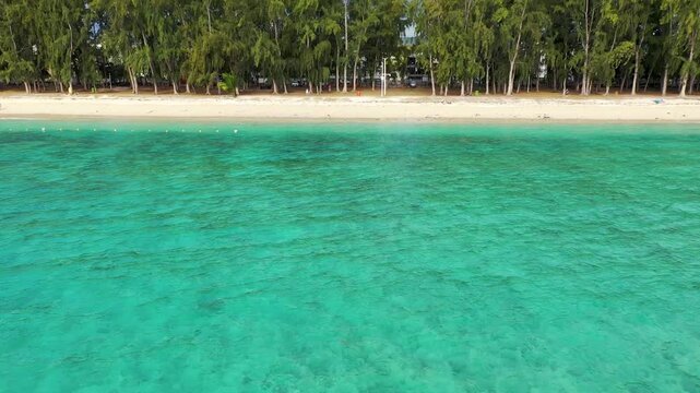 Beautiful Mauritius island with beach Flic en flac. Coral reef around tropical palm beach, Flic en Flac, Mauritius. Aerial view of a beautiful beach along the coast in Flic en Flac, Mauritius.