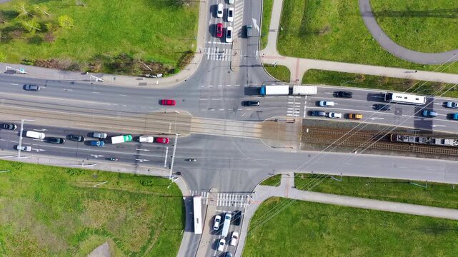 Traffic congestion at a busy intersection in a green urban area during rush hour on a sunny day, Prague, Czechia.