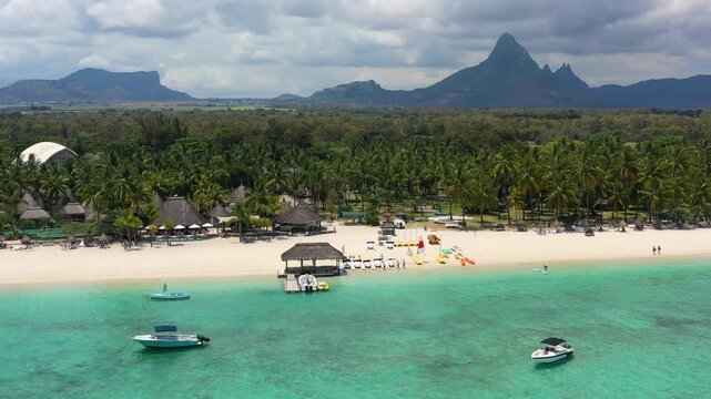 Beautiful Mauritius Island with gorgeous beach Flic en Flac, aerial view from drone. Mauritius, Black River, Flic-en-Flac view of oceanside village beach and luxurious hotel in summer.