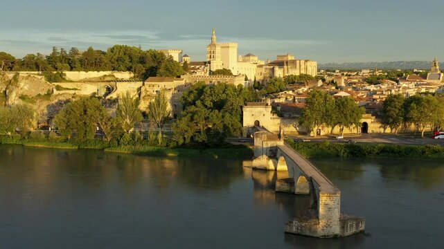 Beautiful view of Avignon with famous bridge Saint-Benezet, medieval architecture along the Rhone River in Avignon, France. The Pont Saint Benezet and the Papal palace in Avignon, South France.