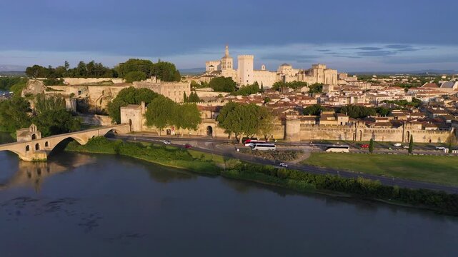Beautiful view of Avignon with famous bridge Saint-Benezet, medieval architecture along the Rhone River in Avignon, France. The Pont Saint Benezet and the Papal palace in Avignon, South France.