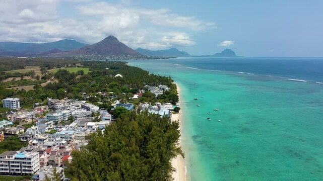 Mauritius, Black River, Flic-en-Flac, Aerial view of coastal beach in summer with Tourelle du Tamarin mountain in distant background. Mauritius island with gorgeous beach Flic en flac.