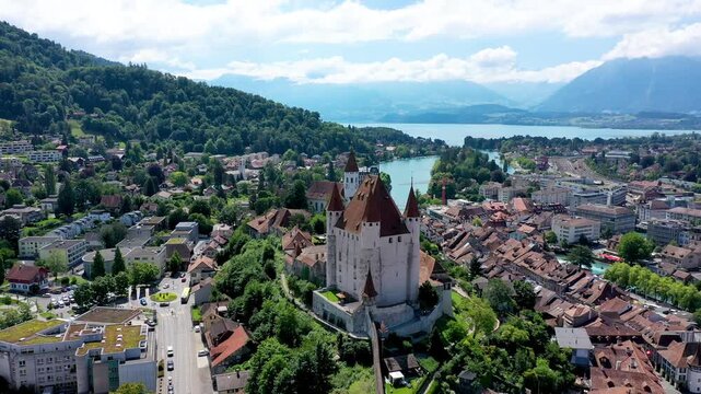 Panorama of Thun city with Alps and Thunersee lake, Switzerland. Historical Thun city and lake Thun with Bernese Highlands swiss Alps mountains in background, Canton Bern, Switzerland.