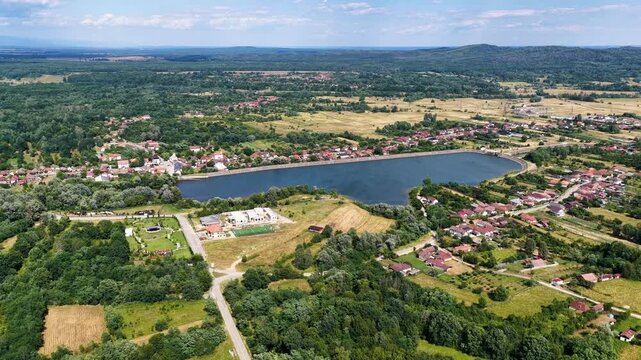 Scenic view of Tismana village in Gorj County Romania under a bright blue sky with fluffy clouds. A stunning landscape captures the beauty of Tismana village in Gorj County. Tismana, Romania.