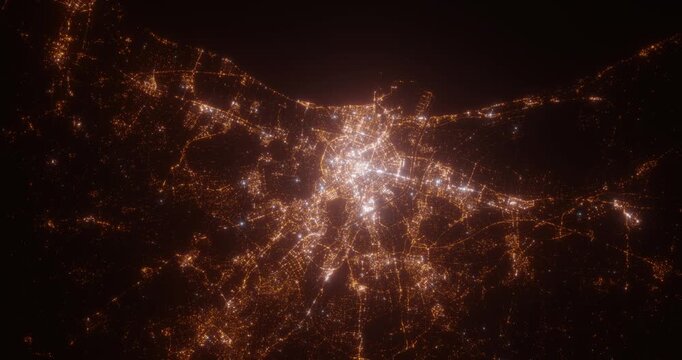 Valencia (Spain) top view at night. Aerial view on modern city with lights. Camera is flying above the city, moving backward. Vertical video. The north is on the left side