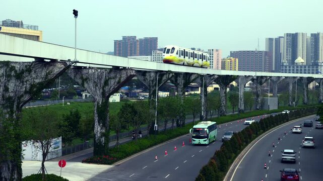 Modern city street landscape with elevated skyrail train traveling above busy road with cars 4K.a futuristic urban transportation system, featuring an elevated skyrail monorail train moving through