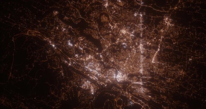 Chattanooga (Tennessee, USA) top view at night. Aerial view on modern city with lights. Camera is flying above the city, moving backward. Vertical video. The north is on the left side