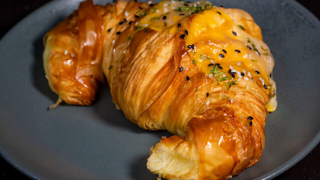 butter croisan with cream topping on plate