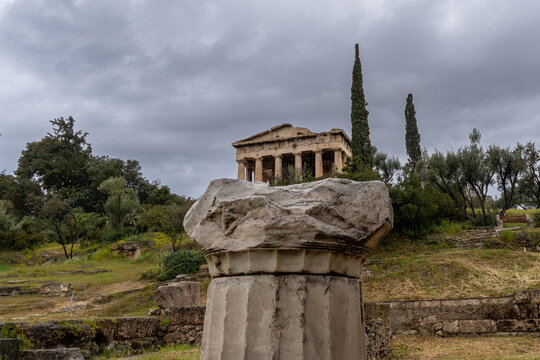 Low angle vertical shot of the ancient Doric columns of the Temple of Hephaestus, showing the impressive stone preservation and architectural detail in the Ancient Agora of Athens, Greece.