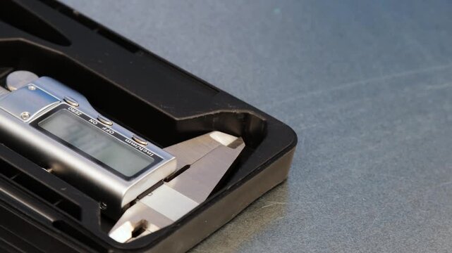 A caliper with an electronic display for measuring parameters.
