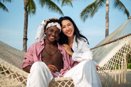 Stylish young multiethnic people in trendy summer outfits enjoying a sunny day at a beach resort
