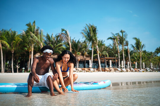 Carefree couple enjoying a tropical beach vacation, laughing making unforgettable memories together