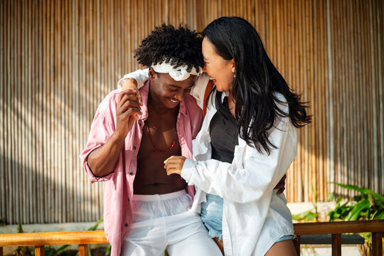 Happy interracial couple embracing and sharing a romantic moment during a tropical island getaway