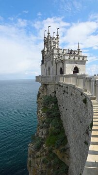 Swallow's nest, a historic neo-gothic castle, dramatically clinging to the steep aurora cliff overlooking the black sea near yalta, crimea, attracting tourists to its unique architectural landmark