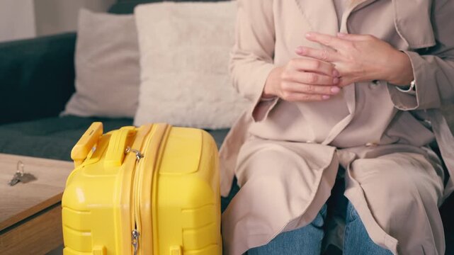 A woman leaves her home with a suitcase after an emotional moment, leaving her keys and wedding ring on the table. Concept of emotional detachment, inner change, and life transformation.