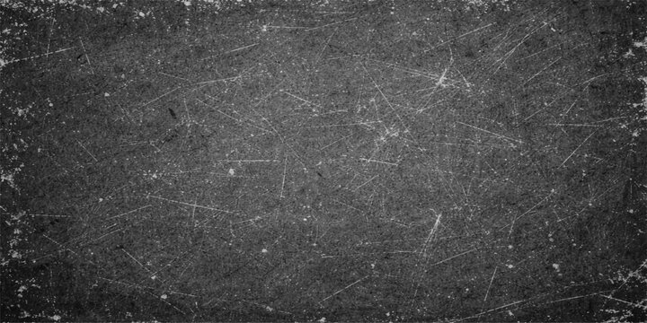 Dark rain drops on a textured black stone wall surface create a moody vintage grunge pattern