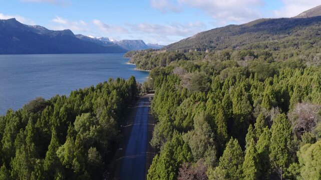 Scenic road through forest along lake on the way to Villa Traful, Patagonia, Argentina.