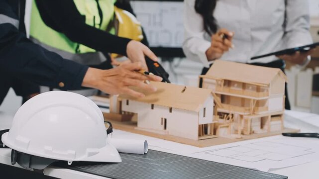 Construction and structure of Engineer or architect meeting for project working with partner and tools on model building and blueprint in working site