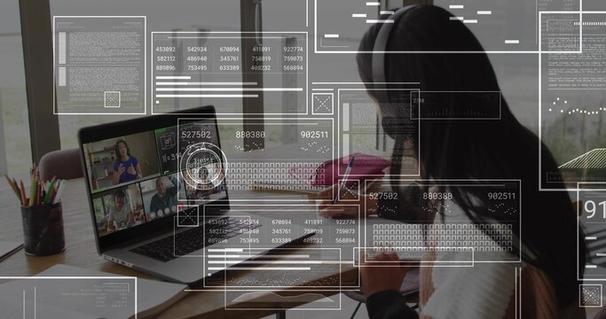 Writing student in headscarf and light sweater on call at home desk with laptop, notebook, HUD