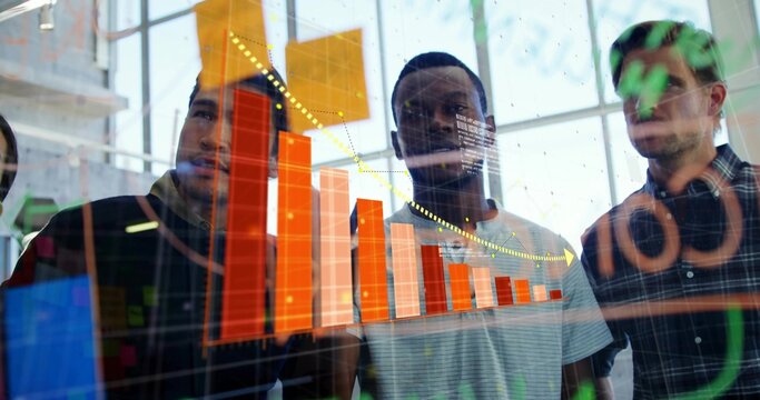 Discussing three men studying orange bar chart on glass display at office with window reflections