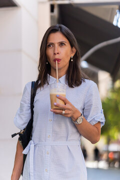 Businesswoman enjoying her iced coffee during break time