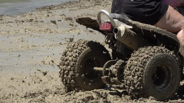 quad biking on muddy terrain