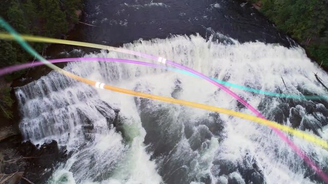 Vertical video: Waterfall, rapids cascading under drone pullback, color arcs showing flow for tech