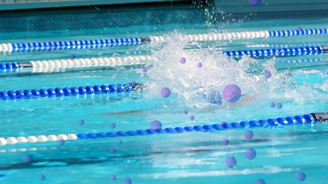 Male swimmer lifting head to breathe and initiating arm pull in swim training, leaving foam trail