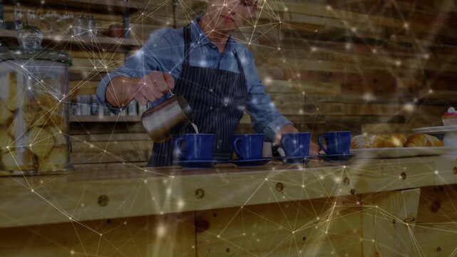 Barista picking pitcher, pouring coffee into four cups to serve orders, net overlay on hands