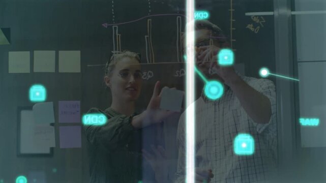 Woman holding sticky note initiating teal HUD while man tracing nodes using tablet for business