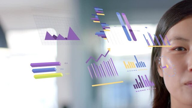 Female exec turning head smiling to 3D charts entering beside her, showing business data