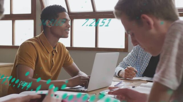 Youth male typing on laptop, leading classmates to study as teal data overlay sweeping across table