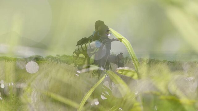 Woman pointing, initiating partner walking to horizon for travel, dew bokeh layer veiling them